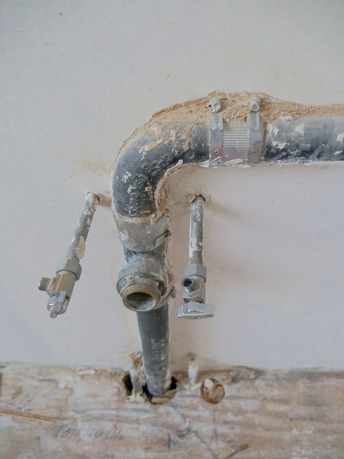 Plumber repairing pipes under a sink
